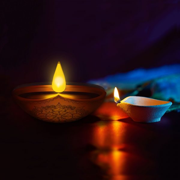 Enlite10 candle next to traditional diwali candle